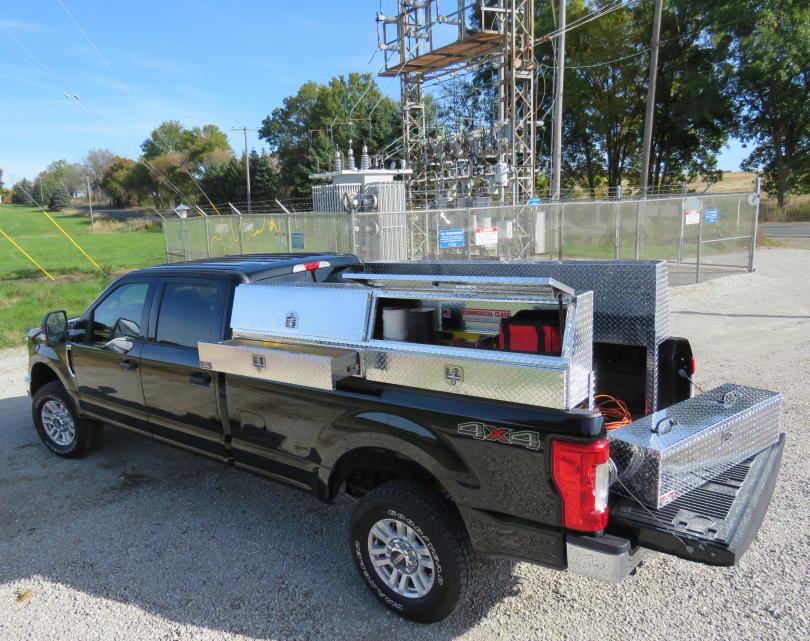 Tool box shown on the back of a pickup truck to show its size