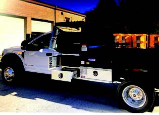 Black pickup truck with large toolbox on a driveway