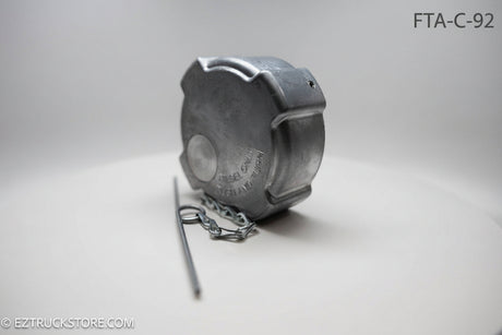 Aluminum fuel cap with chain on a white background