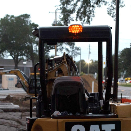 FoxFire Light mounting kit in use on CAT back hoe