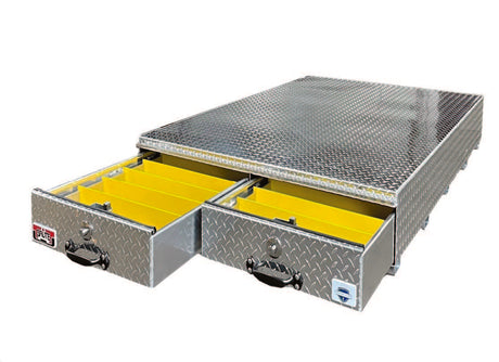 Undercarriage storage box with diamond plate top and yellow drawers on a white background